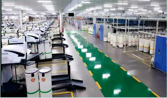 Wide view of the RyderTex knitting floor with circular knitting machines running under high-bay lighting.